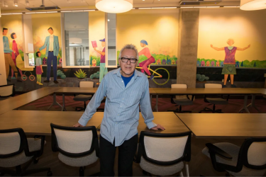 Carlos Frésquez in front of the Board Room Mural